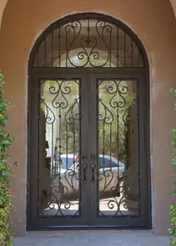 Arched ornamental iron entry door in Coto de Caza