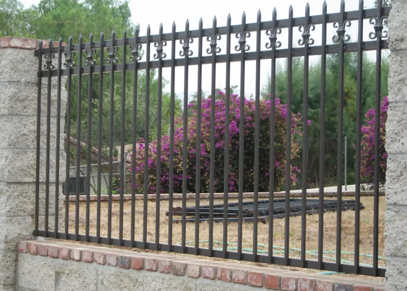 Masonry Property Fence with Iron Topper
