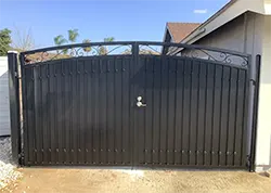 Iron Driveway Gate with Sheet Metal, Scrolls, and Knuckles La Vern CA